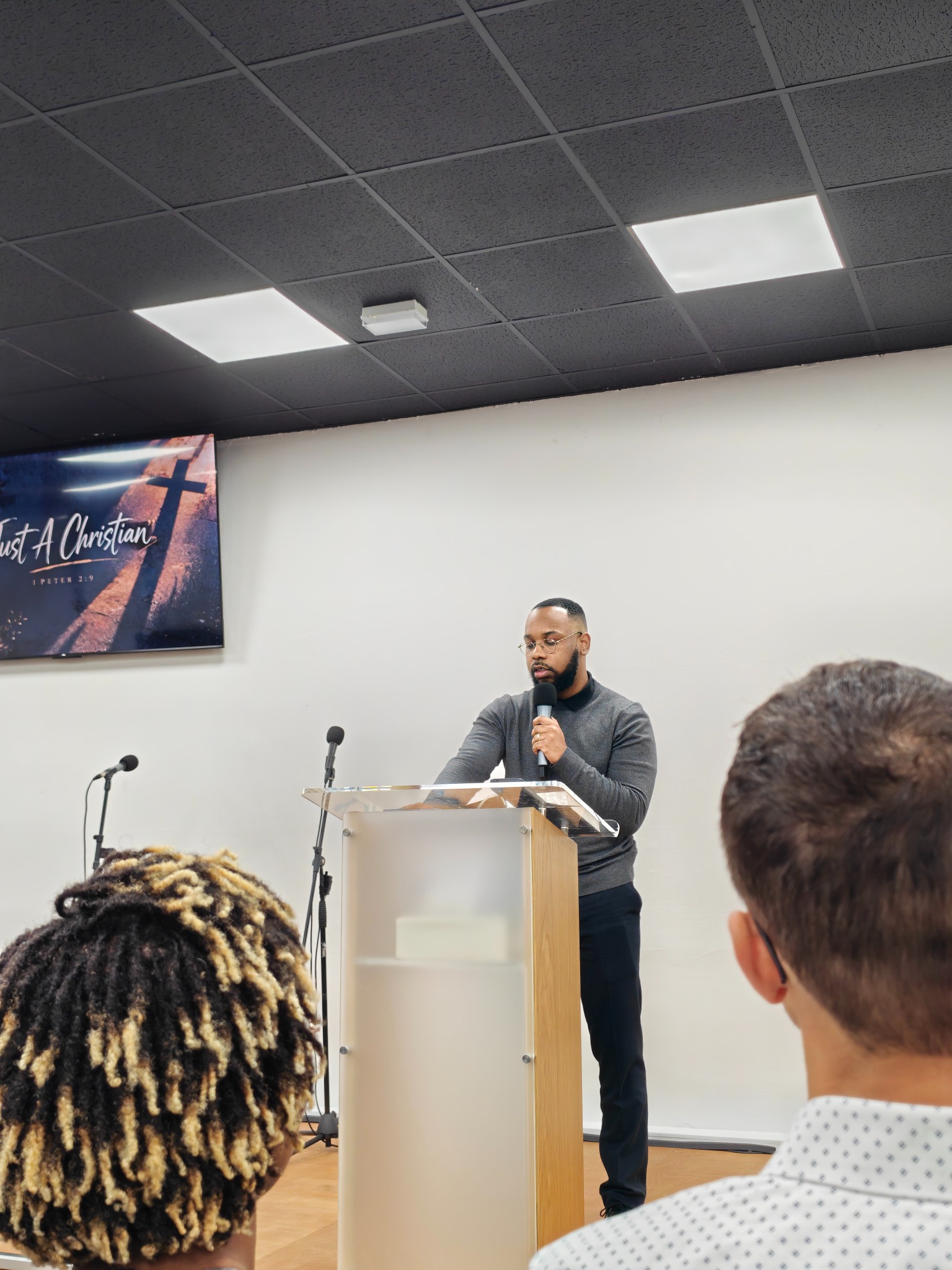 José Santos speaking from a church pulpit